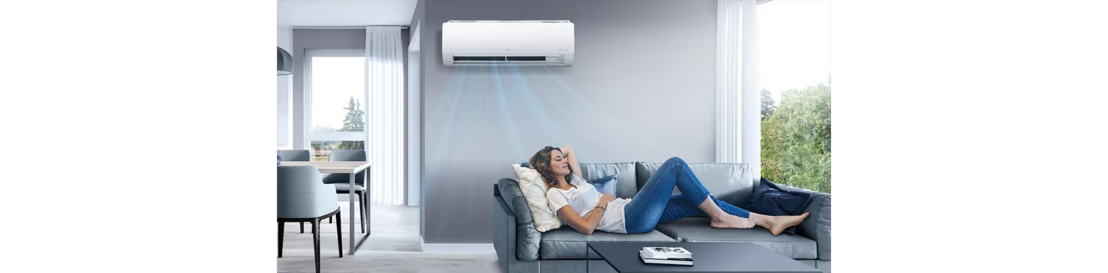 A woman is lying on the sofa, relaxing in the cool air conditioner breeze.