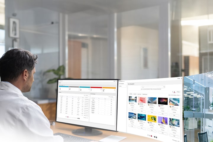 An IT administrator is monitoring devices while viewing the dashboard and equipment management screen of the LG SuperSign Control+ solution.