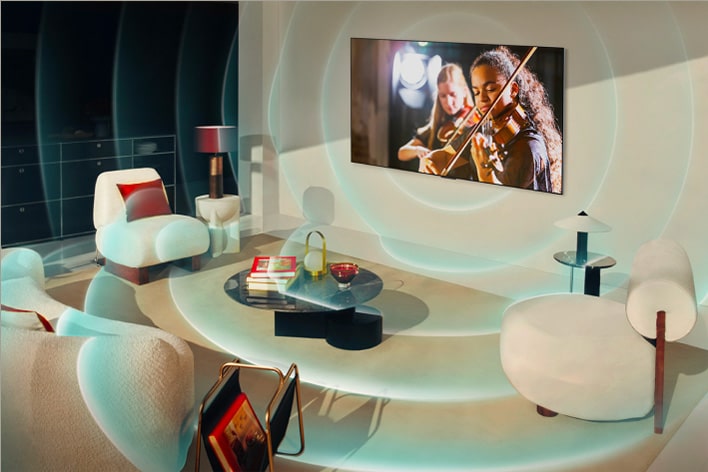 An LG TV is mounted on a living room wall, and bright circles emanate from the TV around the room depicting the soundscape.	