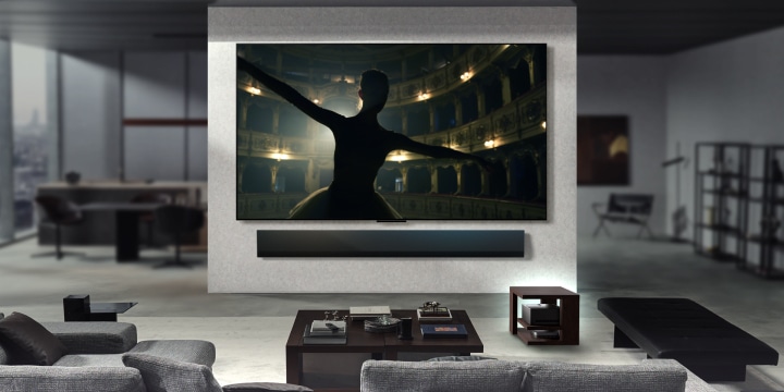 Different living rooms are featured, each with a wall-mounted LG True Wireless TV. In each of these spaces, the setup is neat and tidy. The Zero Connect Box is tucked away under a side table. The content on the screens are rendered in 4K-like definition highlighting the 144Hz video and audio transfer for different content like movies, music, and gaming.