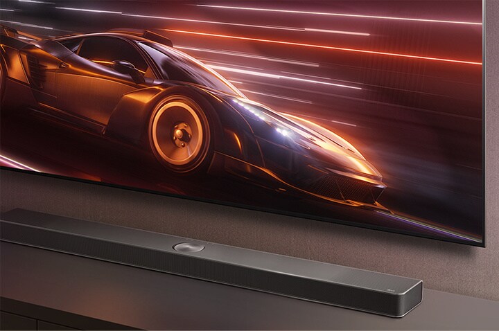 An image of an LG Soundbar and LG TV with a racing car game on screen. 	