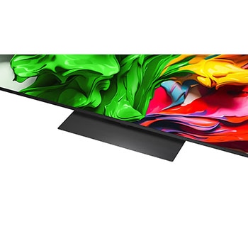 A girl and a dog are seated in front of a LG QNED TV mounted on a wall depicting three elephants walking outwards above a LG Soundbar. The title talks about how every action is more thrilling on a massive screen.