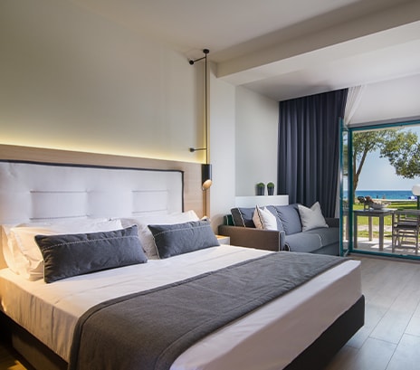 A scene of hotel rooms being cleaned for guests with a view of the blue sea.