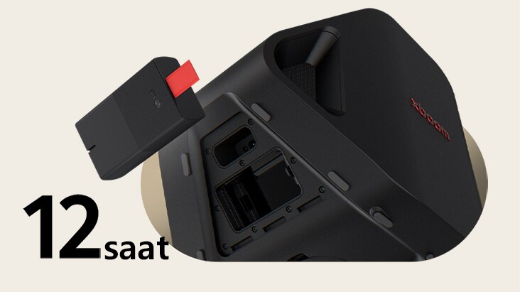 Rear side of Stage 301 is shown with its battert part open. A replaceable battery is hanging on the air right next to the xboom Stage 301.