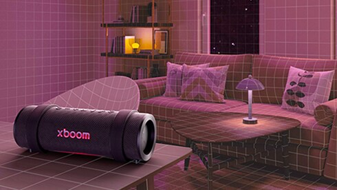 LG XBOOM 擺放在客廳茶几上，周圍環繞著家具。