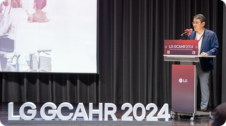 Collage of images from the 2024 LG Alumni Event, including a  speaker on stage, attendees listening, a group photo, and a close-up of an event booklet.	