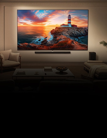 Wall-mounted LG TV with colourful abstract display, paired with a soundbar and subwoofer in a modern living room setting.