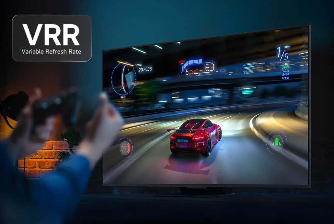 Hands holding a game controller in front of a TV with a car racing game on the screen. VRR, variable refresh rate logo is visible.
