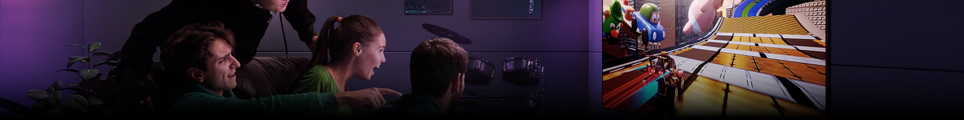 An image of three men playing a racing game on an LG TV in a modern city apartment.