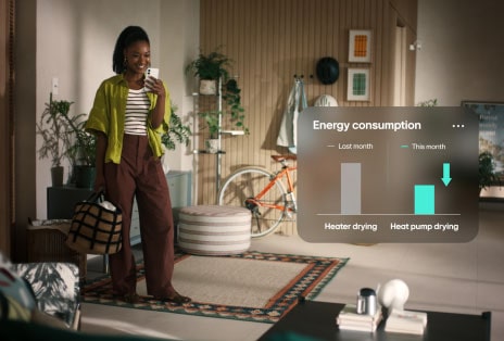 A video of a woman in yellow shirt smiling at her phone with a graph showing reduced energy consumption.