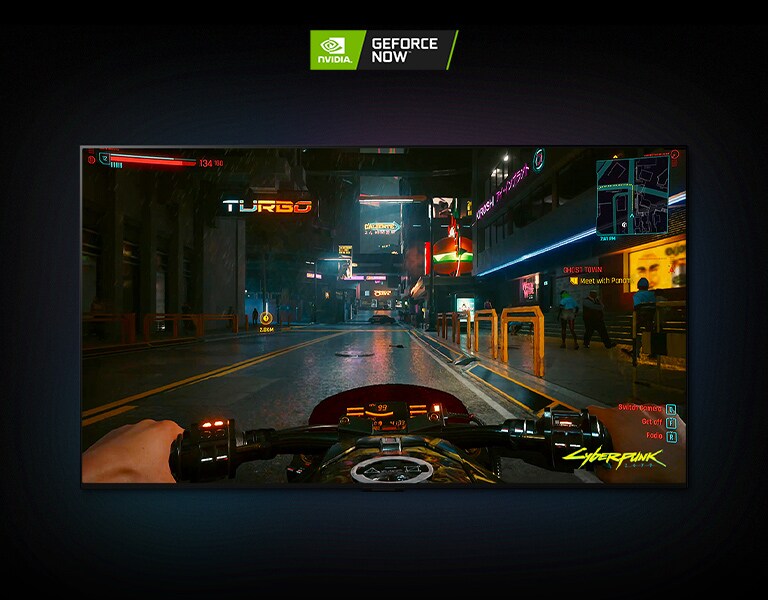 In a scene from Cyberpunk 2077 shown on an LG OLED display, the player drives through a neon-lit street on a motorbike.