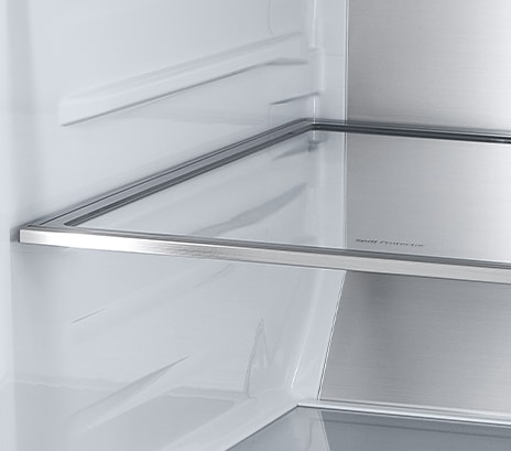 Inside the refrigerator, a slim indoor ice maker is highlighted in blue and the refrigerator is full of ingredients	