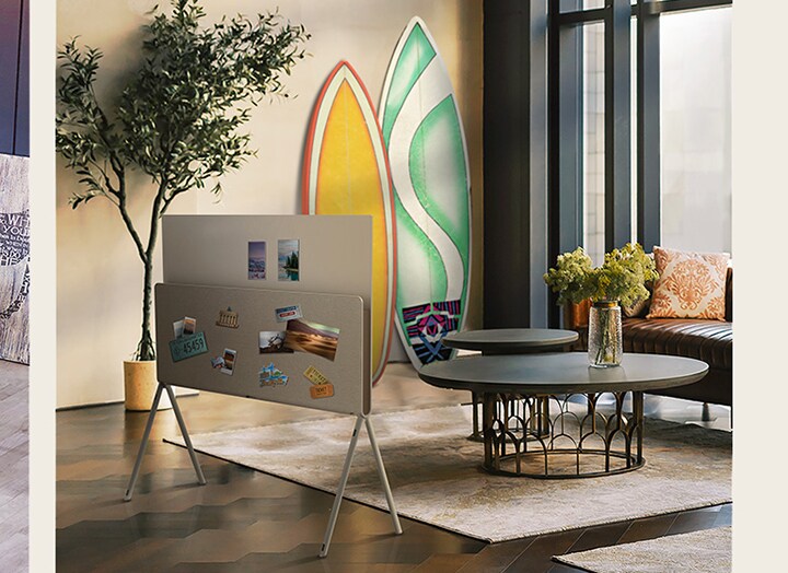 A slide show opens with LG OLED Posé seen from the back with a vinyl album and record placed on the media shelf, next to vinyl records and a guitar. Next, LG OLED Posé is seen from the back with nature magazines placed on the media shelf in a plant-themed living room. Then, LG OLED Posé is seen from the back with postcards, a license plate sticker, photos, and pins placed all over the back as it sits in a warm, bright living room.	