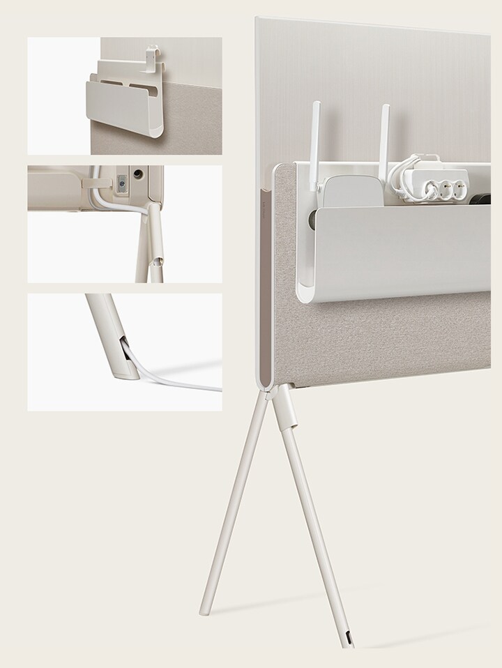 LG OLED Posé’s Cable & Accessory Organiser hangs from the Media Shelf.   LG OLED Posé’s detachable cable holder is seen closeup on the base of the TV.   LG OLED Posé’s cable is seen closeup running out of the TV leg.   LG OLED Posé is seen from the back with the Cable & Accessory Organiser holding a router, outlet, and device.