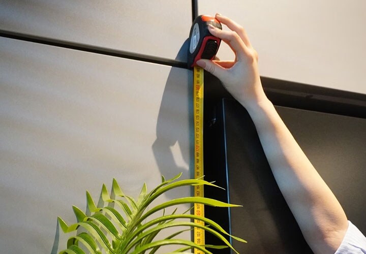 A man measuring his refrigerator size