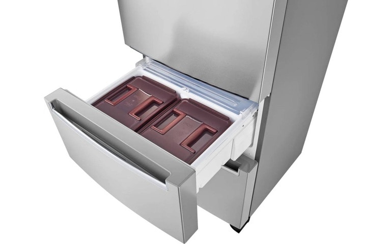 Open drawer of an LG refrigerator containing two brown airtight containers designed for storing kimchi or other fermented foods. The stainless steel fridge emphasises organised and specialised storage within a sleek, modern design.