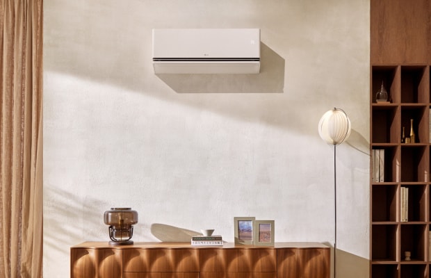 LG air conditioner mounted on the wall. A product cut is shown in the bottom right corner of the image.	