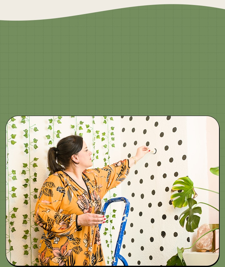 It's an image of a woman decorating a wall.