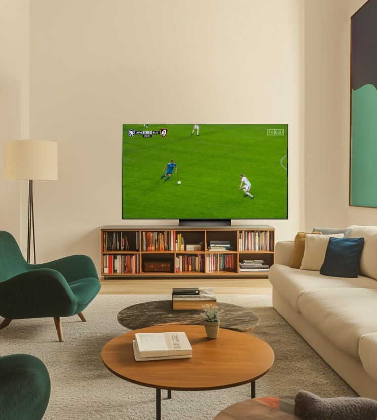 An LG OLED C4 TV is showing a soccer game in a modern living room.