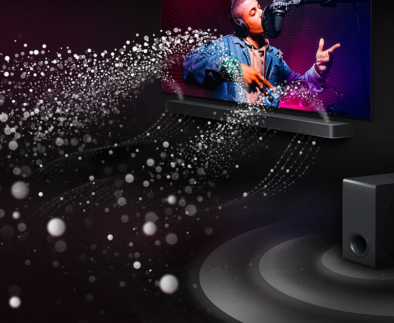 LG Soundbar US90TY and LG TV in a black room playing a musical performance. White droplets representing soundwaves shoot upwards and forward from the soundbar. A subwoofer is creating a sound effect from the bottom.