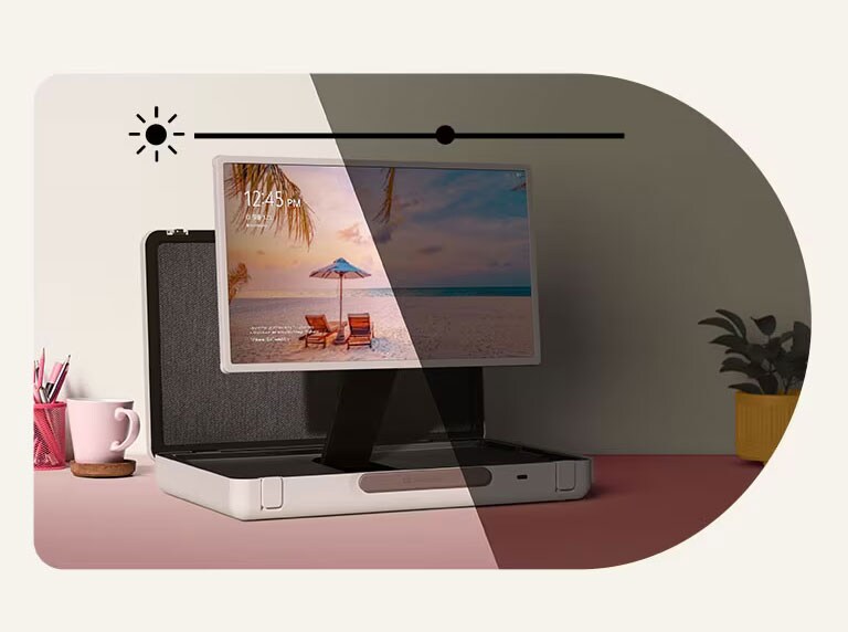 LG StanbyME Go is placed on the pastel colored table with left side forward. On top of the image, the brighness icon is shown. To illustrate auto brightness control feature, half of the image is bright and the other half is dimmed.