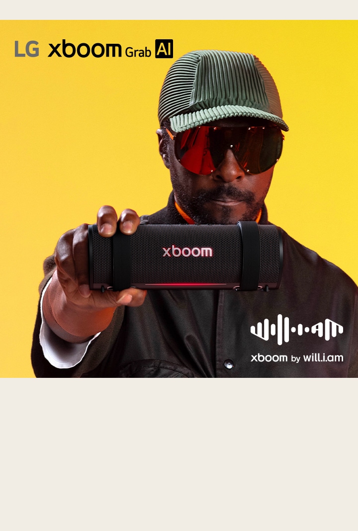 will.i.am in black outfit and sunglasses is holding xboom Grab to the front.