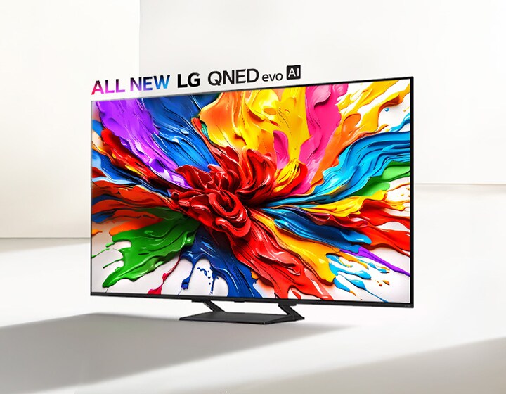 LG QNED TV on a stand in a dominantly white space. On the TV screen is a colorful splash of paint showcasing how QNED TVs can display a wide range of vibrant colors with pleasing contrast. The all new LG QNED evo AI logo is positioned above the TV. 