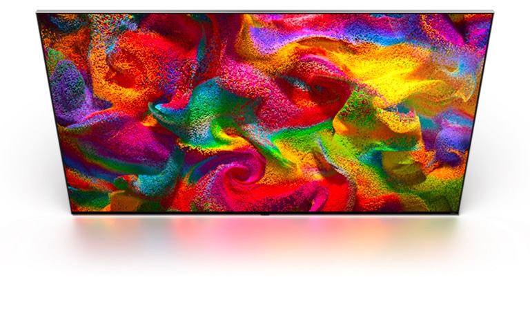 Multi-colored sand explodes in all directions, forming a swirling pattern, then appears as the display of an LG TV.	