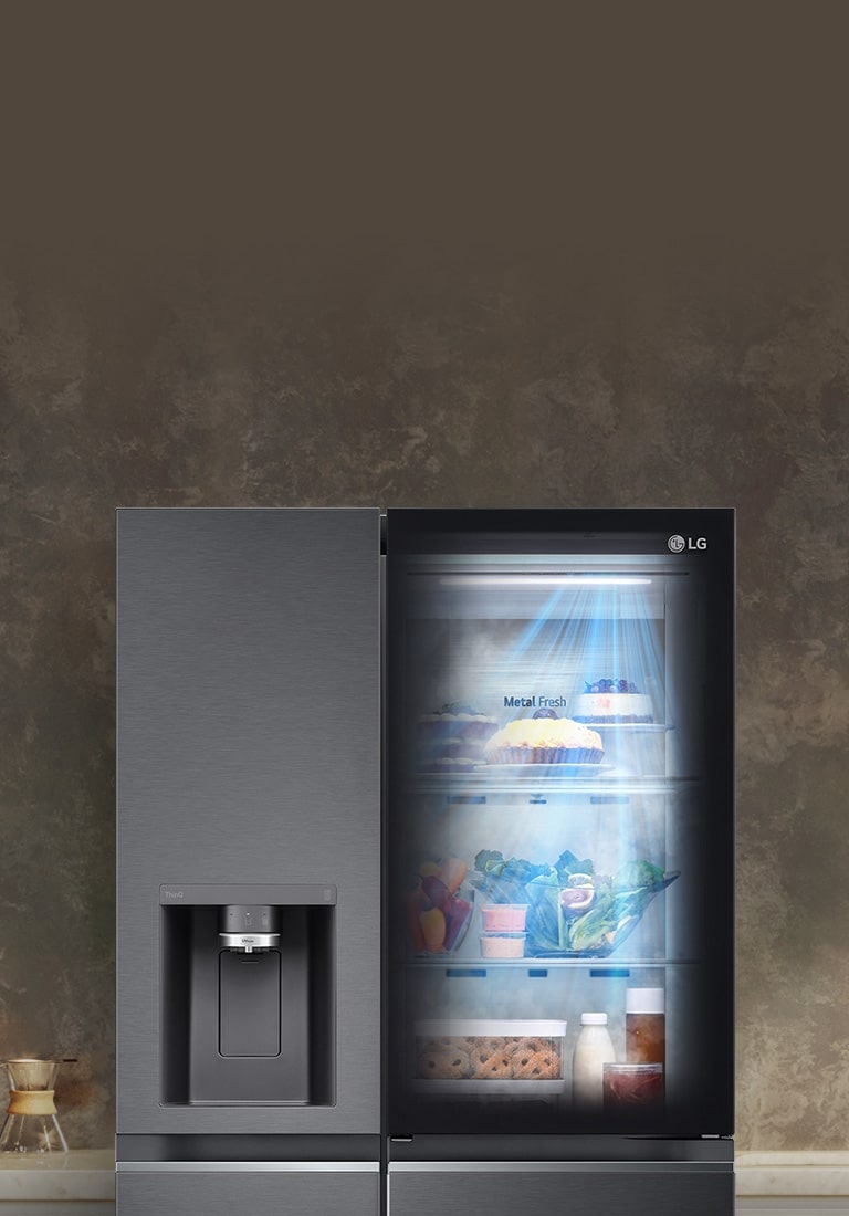 The front view of a black InstaView refrigerator with the light on inside. The contents of the refrigerator can be seen through the InstaView door. Blue rays of light shine down over the contents from the DoorCooling function.