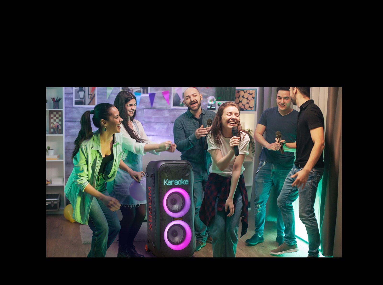 There are people enjoying karaoke in the living room.
