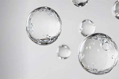 Transparent water bubbles floating on light gray background