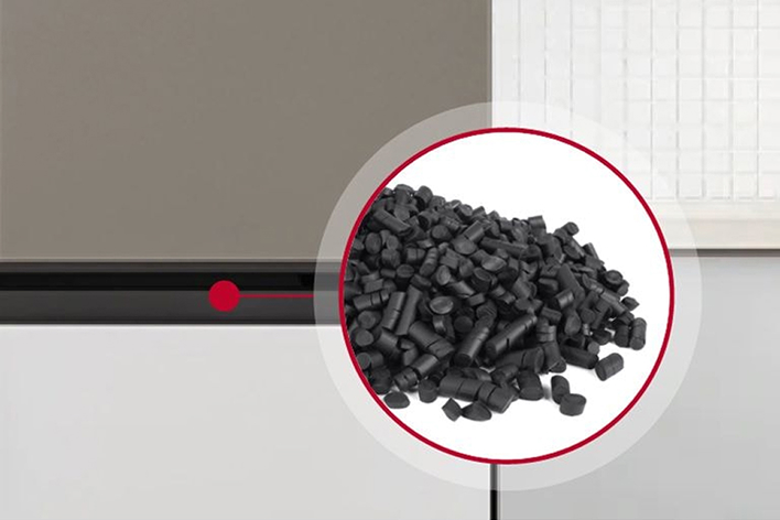 Close-up of black plastic polymer pellets used in manufacturing.