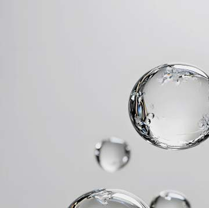 Transparent floating bubbles on light gray background	