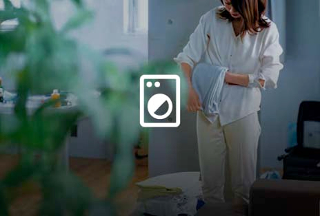 Woman folding laundry at home