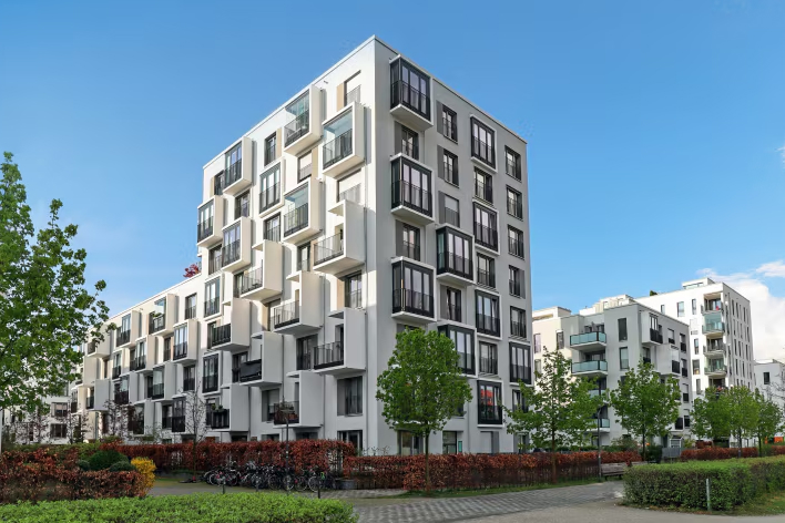 Modern multi-housing apartment complex with trees and landscaping