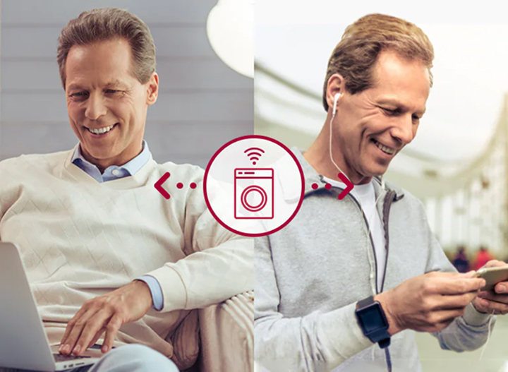 Middle-aged man using LG Smart Laundry system remotely via laptop and smartphone, highlighting wireless control, real-time monitoring, and flexible business management.