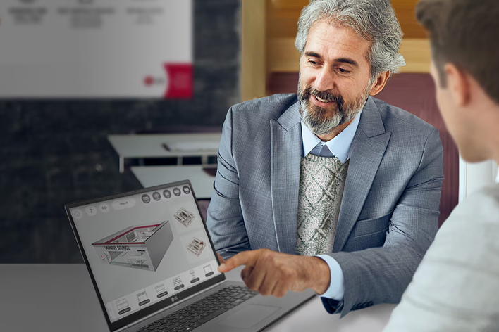 Business consultant using LG VR simulator on a laptop to design an optimized laundromat layout, showcasing 3D virtual planning and profitability analysis.