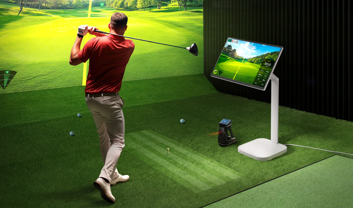 A man is playing golf at an indoor screen golf facility, with a LG Smart Monitor Swing next to him displaying data.	