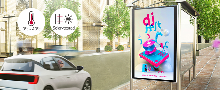 A woman in a car is looking at a DOOH (Digital Out Of Home media) ad on the side of the road. Via a solar test conducted inside LG, this product can operate at wide range of temperature of 0 to 40 degrees.