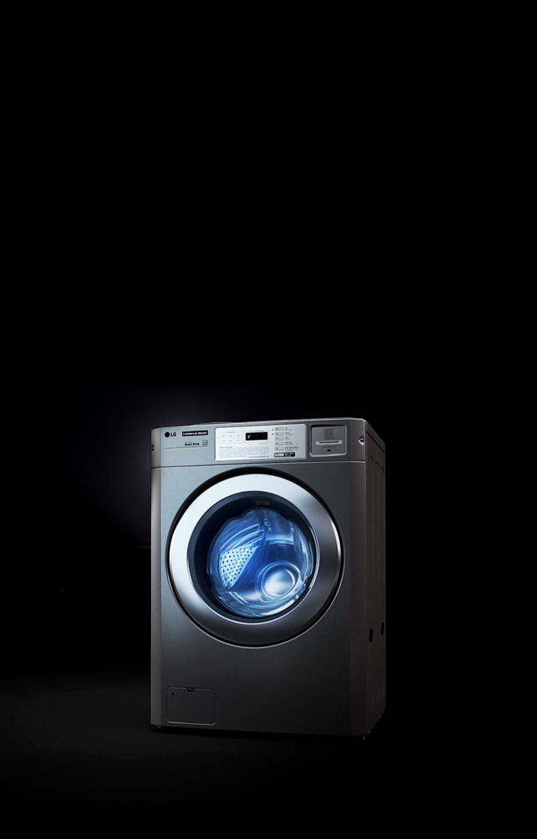 The image of the solitary LG Commercial Laundry is illuminated by a spotlight against a dark background.