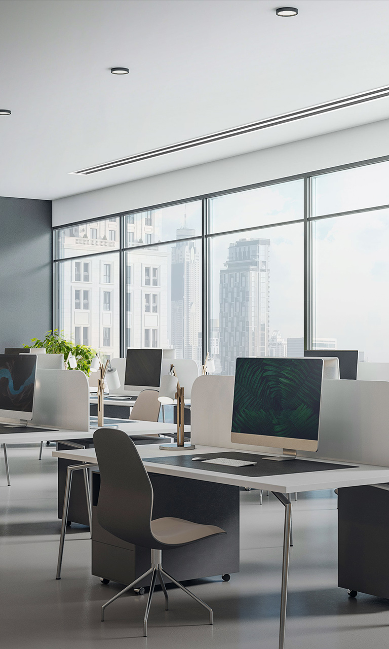In the office, an LG Ceiling Concealed Duct is mounted on the right-hand side of the white wall, with a clock hanging on the navy wall opposite.