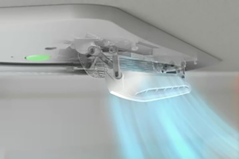 The solid white part of the dual vane moves up and down, distributing a light blue airflow into the surrounding environment.