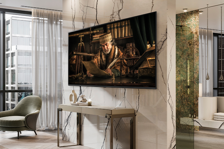 A TV hanging on the hotel wall shows a vivid and bright screen.