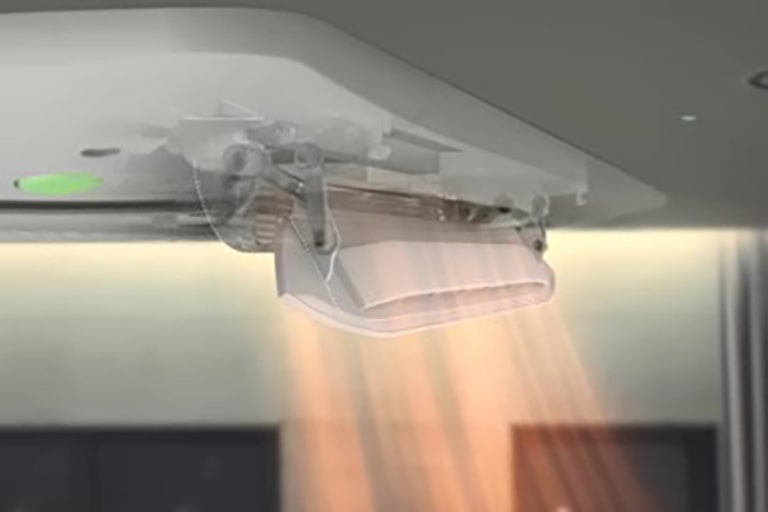 The solid white part of the Dual Vane Cassette distributes slightly red airflow directly toward two individuals positioned below it.