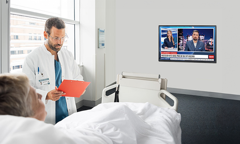 An LG commercial TV is installed in a hospital room.