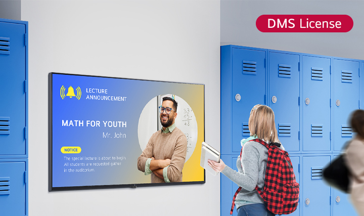 This image depicts a student viewing content on a digital signage screen in the school hallway. The displayed notification says, &quot;MATH FOR YOUTH&quot;(special session for math), instructing students to gather in the lecture hall.