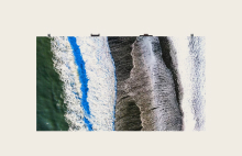 LG digital signage showing aerial view of ocean waves with high-definition clarity. LG display solutions providing natural, realistic visuals for creative and commercial applications