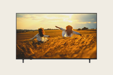 LG commercial display with vivid imagery of children playing in wheat field.