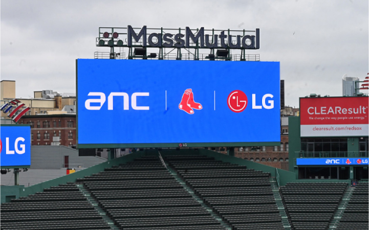 LG large stadium LED display at Fenway Park featuring Red Sox branding. LG sports signage solutions delivering high-visibility digital content for fans.