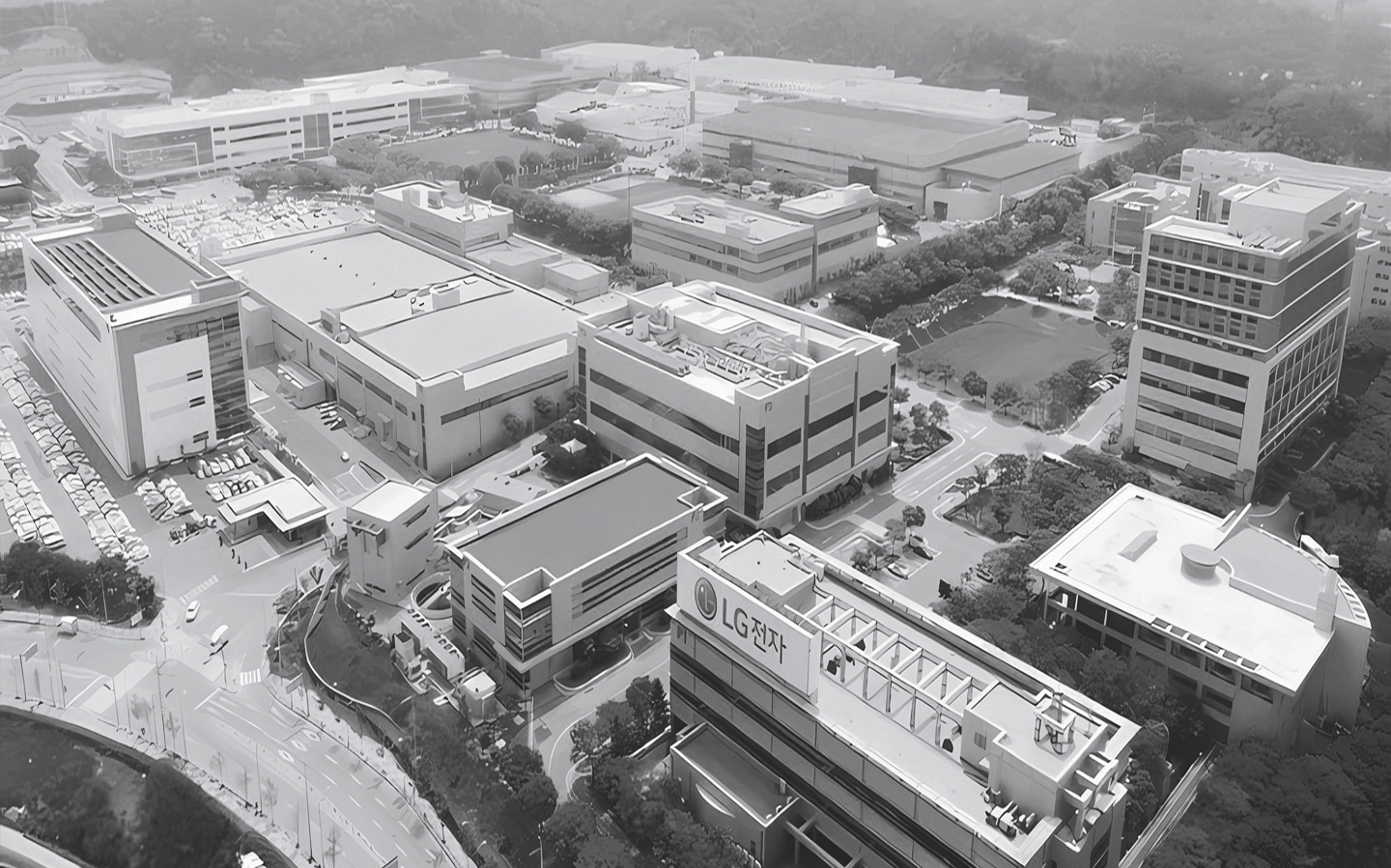 Aerial view of LG Electronics industrial complex with multiple factory buildings, parking lots, and green spaces."